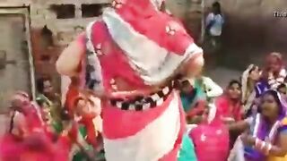 The village woman is dancing showing off her tits