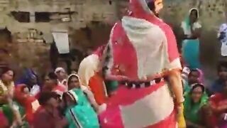 The village woman is dancing showing off her tits